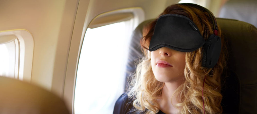 sleep mask - best sleep mask - sleep mask for night shift - shift workers sleep mask - travel sleep mask - sleep mask block snoring - sleep mask reduce noise - sleep mask block noise - woman traveling on plane with sleep mask - travel sleep mask flying