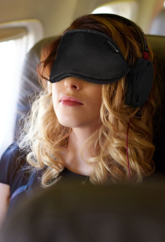 sleep mask - best sleep mask - sleep mask for night shift - shift workers sleep mask - travel sleep mask - sleep mask block snoring - sleep mask reduce noise - sleep mask block noise - woman traveling on plane with sleep mask - travel sleep mask flying 